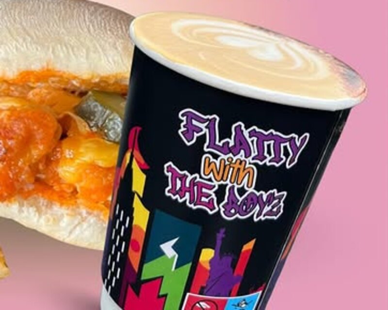 A Bean Box signature sandwich beside a branded flat white